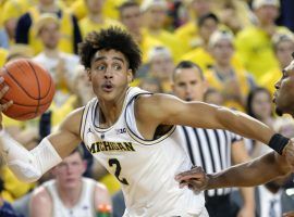 Michigan guard Jordan Poole works against Northwestern guard Anthony Gaines during their game in Sunday, Jan. 13. (Image: Kirthmon F. Dozier/Detroit Free Press)