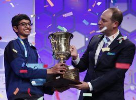 Karthik Nemmani, 14, holds the Scripps National Spelling Bee Championship Trophy with Scripps President and Chief Executive Officer Adam Symson after winning last yearâ€™s contest. (Image: AP)