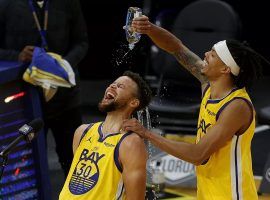 Damion Lee of the Golden State Warriors pours water to cool down a hot Steph Curry after a career-high 62 points. (Image: Porter Lambert/Getty)